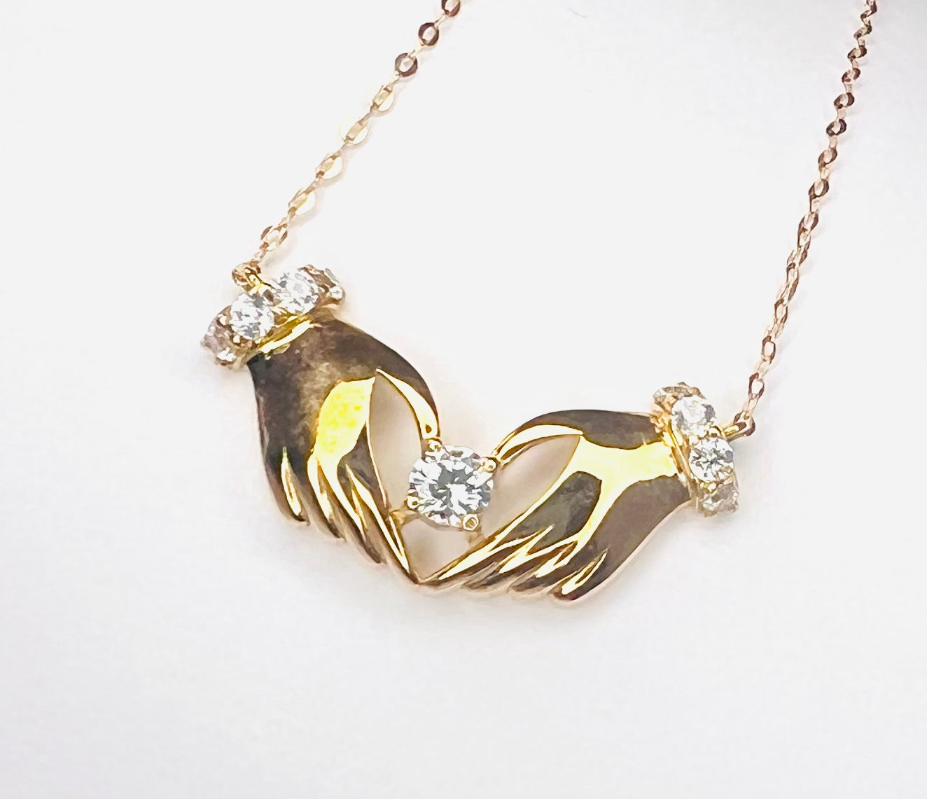 18k gold necklace with hands & heart pendant